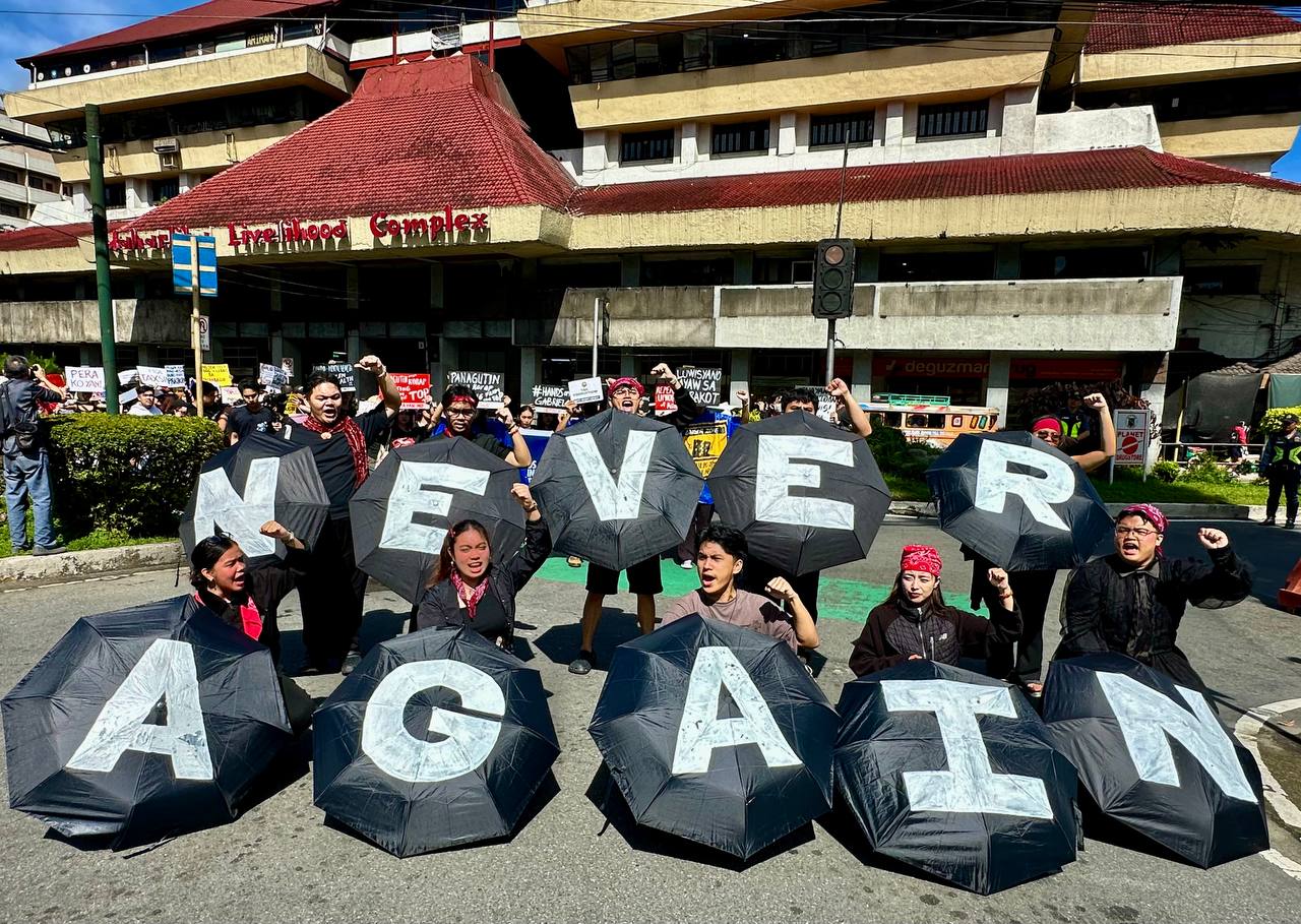 Never again banner at Sept. 21 protest